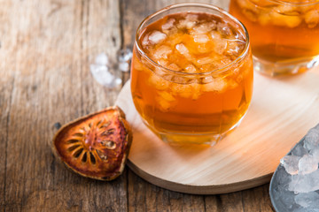 Bael juice ice tea on wooden table , healthy drink