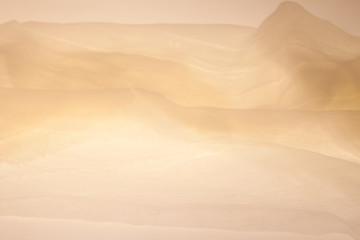 Abstract bright colorful fabric background in the form of a wave