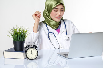 Veiled medical staff with clock. Time management concept.