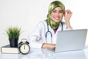 Veiled medical staff with clock. Time management concept.