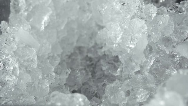 Close-up of a man with a shovel takes ice crush for a cocktail. Making of a cocktails. Negroni.