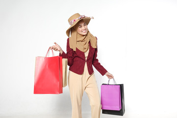 Portrait of a beautiful young muslim woman with shopping bags