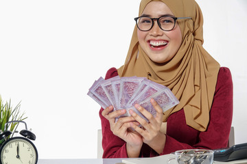 Beautiful lady happily  holding and showing money isolated on a white background