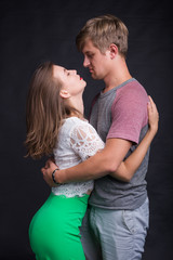 Passionate young people in love on black background