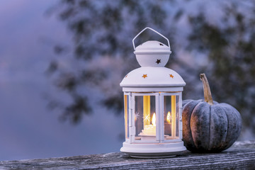 Naklejka premium White lantern on wooden pier