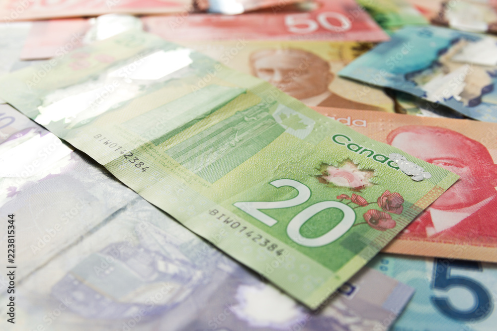 Wall mural canadian currency. dollars. full frame of bills spread on table and assorted amounts.