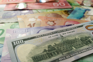 Paper notes from Canada and USA. Different amounts of bills.