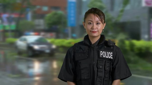 Asian American Woman Police Officer Smiles at Camera
