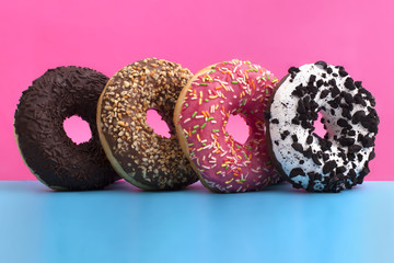 Different donuts on blue and pink background