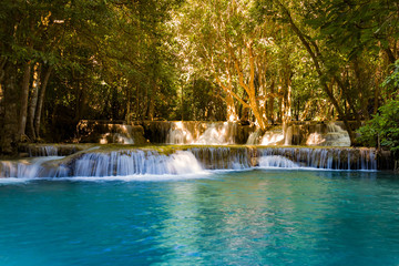 Blue stream deep forest waterfall in tropical natural landscape background © pranodhm