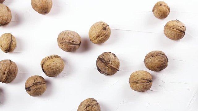 Close up of walnuts on whti texture surface.