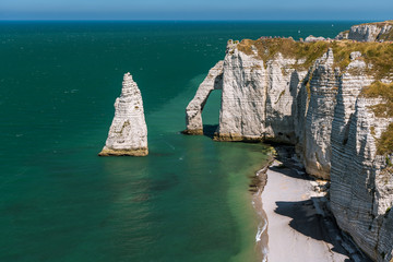 Fototapeta premium Chalk cliffs of Etretat with the natural arch Porte d'Aval and the stone needle called L'Aiguille