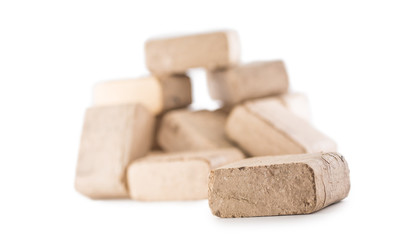 Wooden pressed briquettes from biomass on a white isolated backg