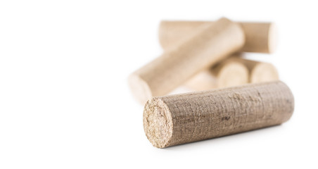 Wooden pressed briquettes from biomass on a white isolated backg