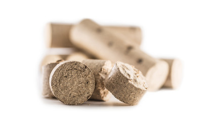 Wooden pressed briquettes from biomass on a white isolated background.