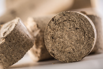 Close-up wooden pressed briquettes from biomass