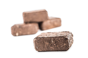 Wooden pressed briquettes from biomass on a white isolated background