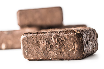 Wooden pressed briquettes from biomass on a white isolated background