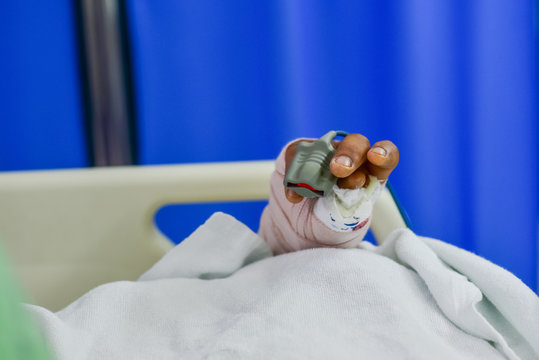 Patient finger with pulse oxymeter in the hospital.