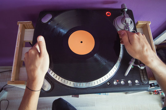 Top View Man Puts A Vinyl Record In The Player