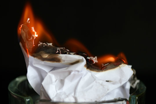 A Piece Of Paper Burning In A Glass Ashtray Close Up