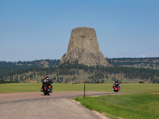 Bikers driving to Devils Tower National Monument at the Sturgis Motorcycle Rally in the Black...