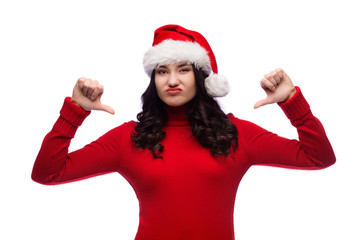Brunette girl wearing christmas hat showing dislike with thumbs down, rejection concept, Isolated