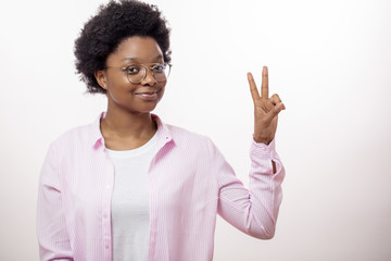 awesome positive african female showing two finger to the camera, victory sign, gesture, body...
