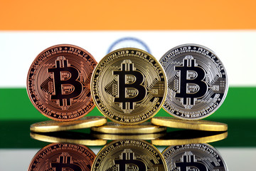 Physical version of Bitcoin (BTC) and India Flag. Conceptual image for investors in High Technology (Cryptocurrency, Blockchain Technology, Smart Contracts, ICO).