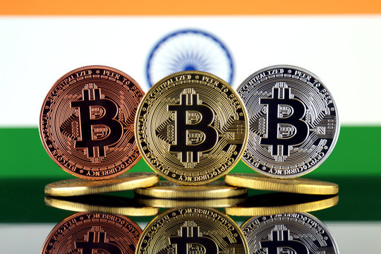 Physical version of Bitcoin (BTC) and India Flag. Conceptual image for investors in High Technology (Cryptocurrency, Blockchain Technology, Smart Contracts, ICO).