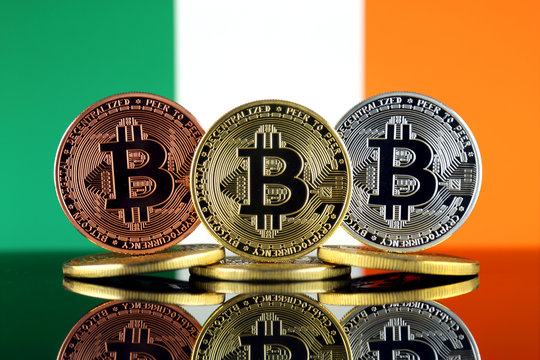 Physical version of Bitcoin (BTC) and Ireland Flag. Conceptual image for investors in High Technology (Cryptocurrency, Blockchain Technology, Smart Contracts, ICO).