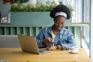 African American business woman uses a smart watch to view incoming messages and calls to smart...