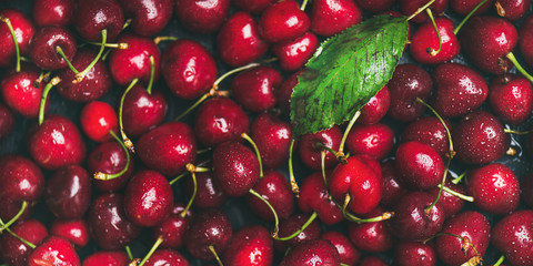 Fresh sweet cherry texture, wallpaper and background. Flat-lay of wet sweet cherries, top view. Summer food or local market produce concept