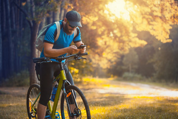 bearded man cyclist rides in the forest on a mountain bike.