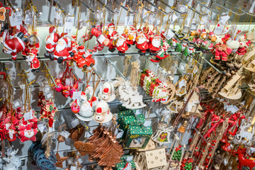 Fototapeta premium Santa Claus, reindeer, Christmas tree and other souvenirs New Year concept hanging on the shelf