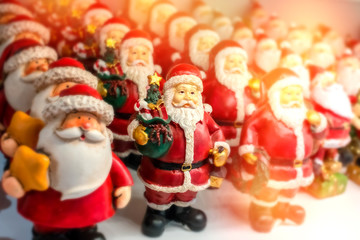 a lot of Santa Claus stand on the shelf of the souvenir shop, soft focus