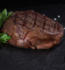 Beef medallion steak on a black background