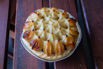 Delicious potato pie on a wooden table