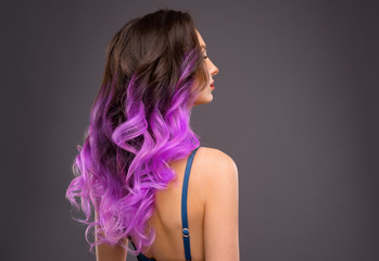 Woman with Long Healthy Colorful Ombre Lavender Wavy Hair. Close Up of Hairstyle. Care and Hair Products