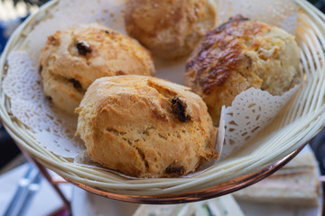 Freshly baked scones in a basket at high tea