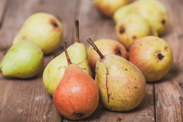 Several ripe pears lie on boards