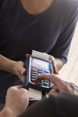 Credit card swipe through terminal for sale in store. Shopping and retail concept