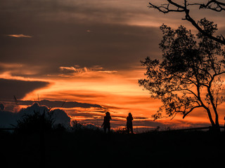 2 tourists took a photo and watched the sunset at the top of the mountain, on the day of mangkhut storm.Located about 1,633 meters above sea level, Phoosoidao, Uttaradit, Thailand.