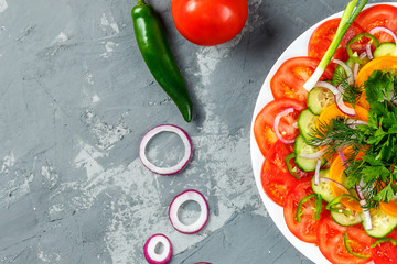 Cooking vegetables on the gray background top view