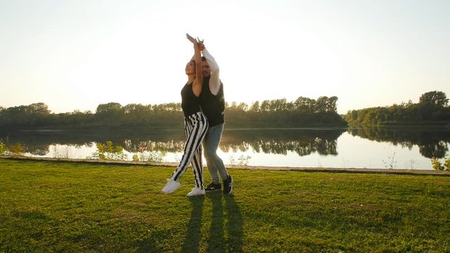 Concept of love and relationships Couple dancing bachata at sunset