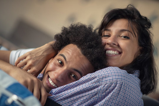 Cropped Shot Of A Young African American Couple Watching Television At Home