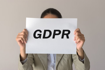 GDPR. A young woman is hidden behind the inscription General Data Protection Regulation. Cyber security and privacy.