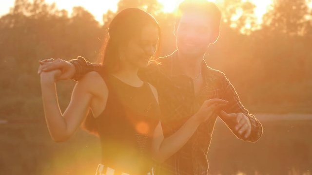 Concept of love and relationships Couple dancing bachata at sunset