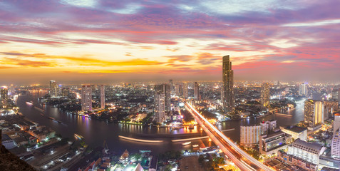 Thailand Bangkok city skyline.Scenic cityscape of Bangkok with dramatic sky before sunset with modern skyscraper and Chao Phraya river in background. © MemoryMan