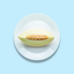 Melon sliced on pastel blue background. Minimal fruit concept.